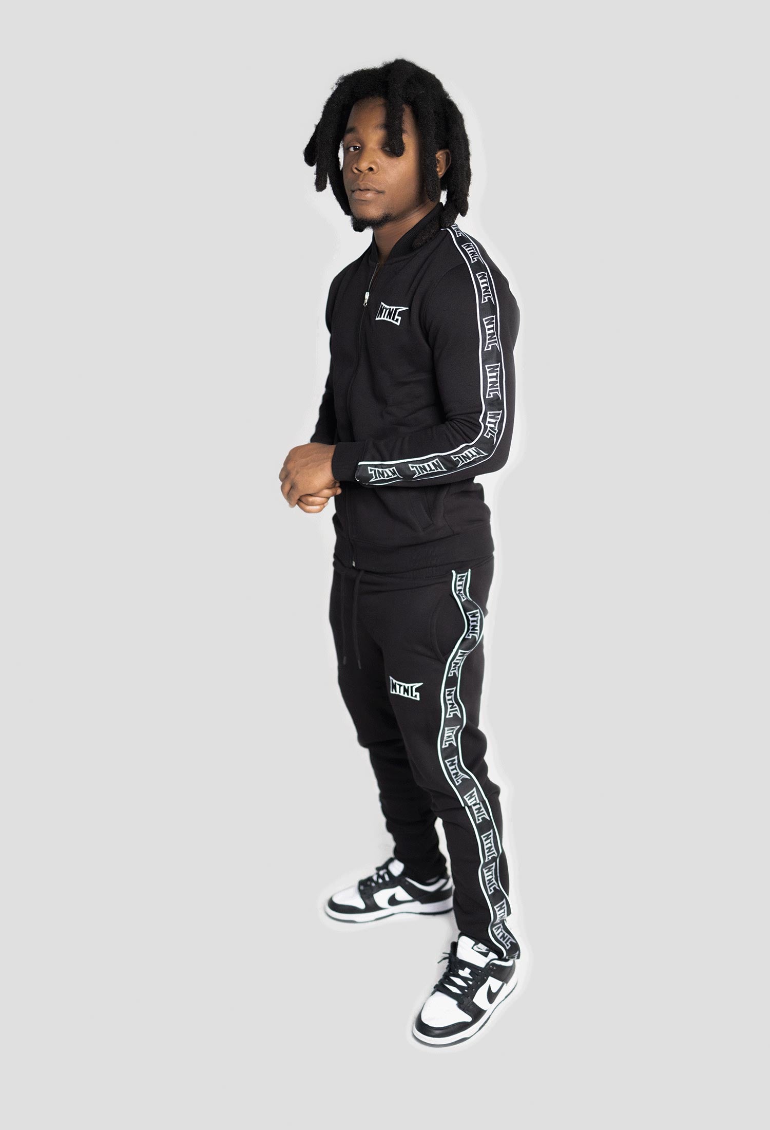 MALE MODEL WEARING BLACK 3M TRACKSUIT 