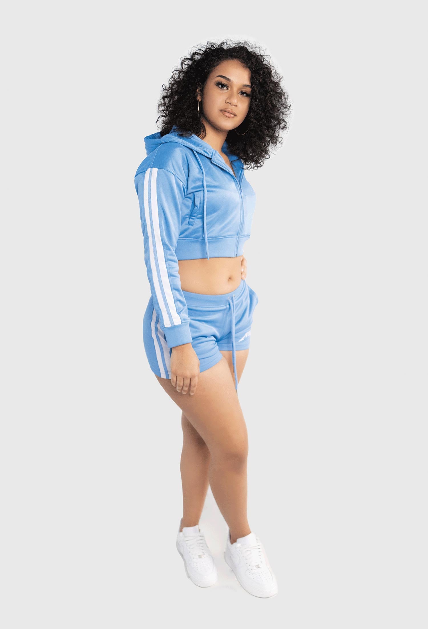 FEMALE SIDE PROFILE WEARING SIZE M SKY BLUE TRACK JACKET & PANTS 